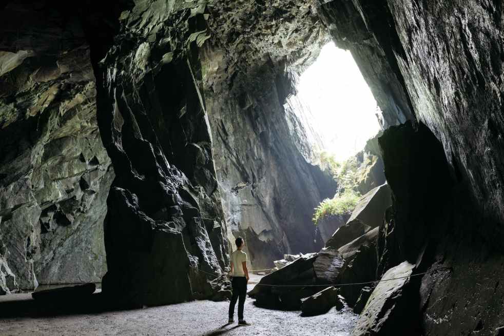 person standing inside cave | lookingjoligood.blog